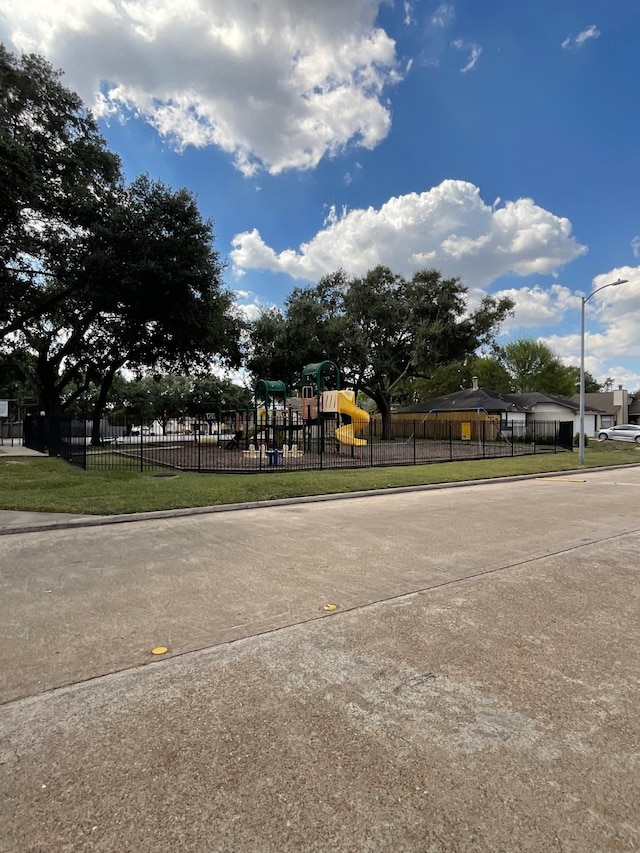 view of property's community featuring a playground and a lawn