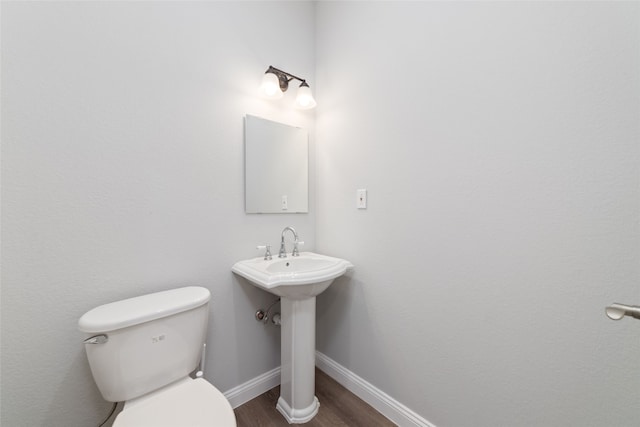 bathroom featuring sink, toilet, and hardwood / wood-style flooring