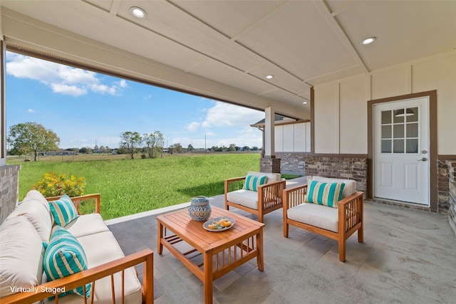 view of patio with outdoor lounge area and a rural view