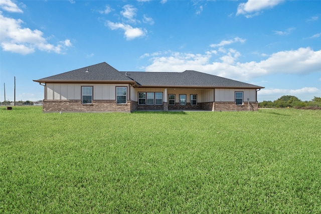 back of house with a lawn