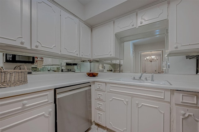 kitchen featuring a notable chandelier, dishwasher, sink, and white cabinets