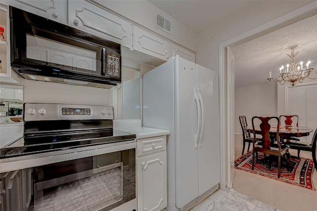 kitchen featuring stainless steel electric range oven, white cabinetry, white fridge, a notable chandelier, and a textured ceiling