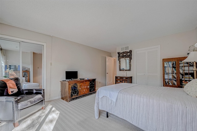 carpeted bedroom with a textured ceiling