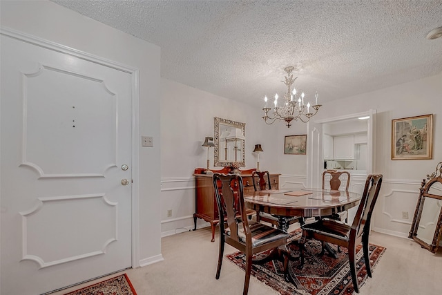 carpeted dining space featuring a textured ceiling and a chandelier