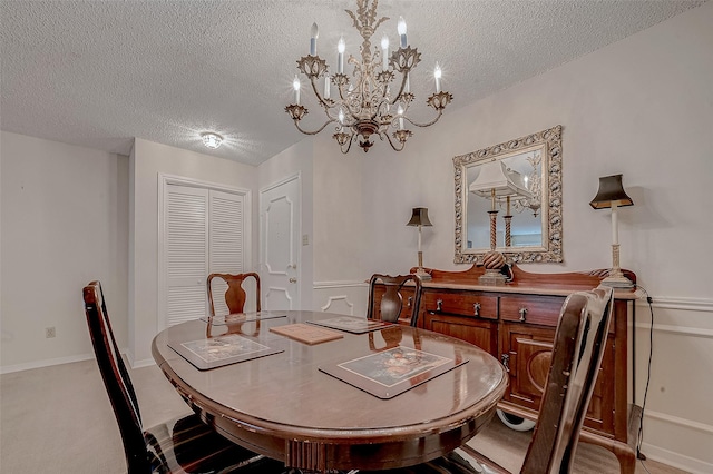 carpeted dining space featuring an inviting chandelier and a textured ceiling