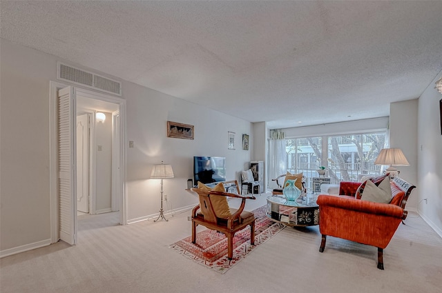 carpeted living room with a textured ceiling