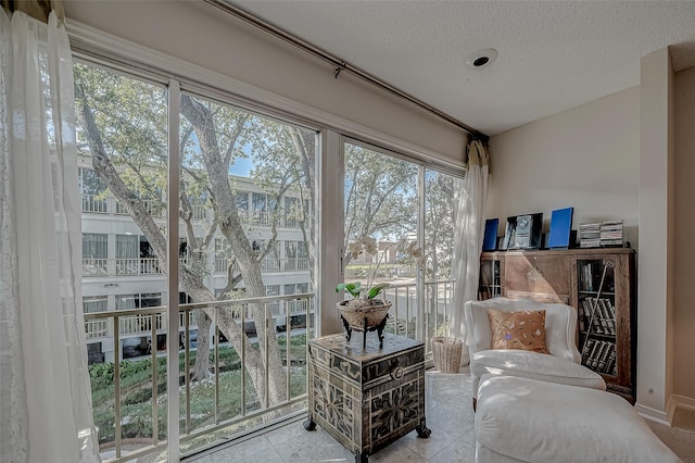 living area featuring light tile patterned floors and a textured ceiling