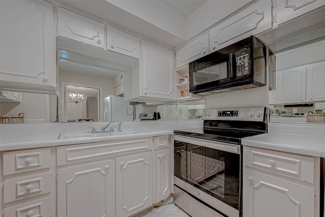 kitchen with sink, white cabinetry, white refrigerator, stainless steel electric range oven, and a chandelier