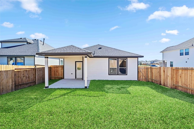 rear view of property featuring a yard and a patio