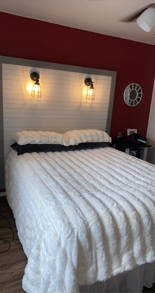 bedroom with dark wood-type flooring