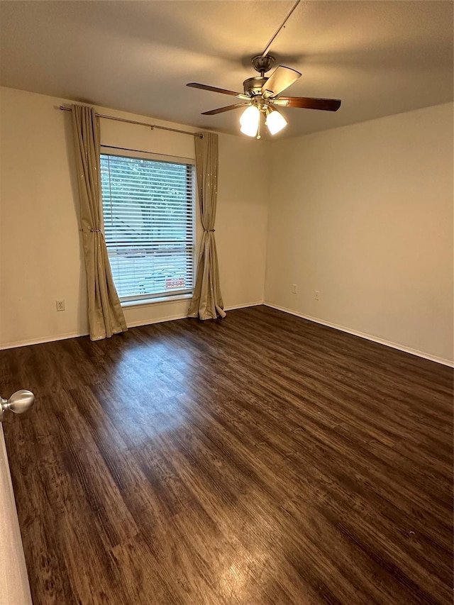 empty room with ceiling fan and dark hardwood / wood-style floors