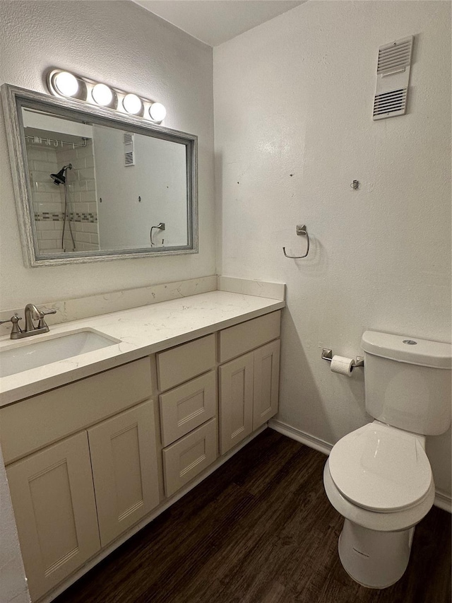 bathroom featuring hardwood / wood-style flooring, vanity, and toilet