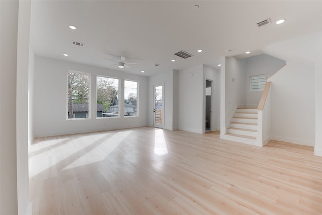 unfurnished living room with ceiling fan and light hardwood / wood-style floors