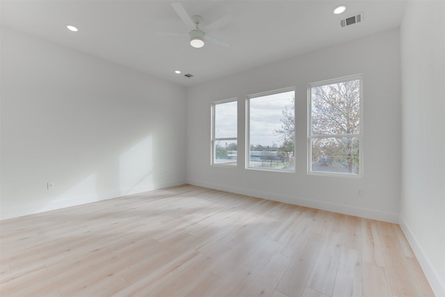 spare room with light wood-type flooring and ceiling fan