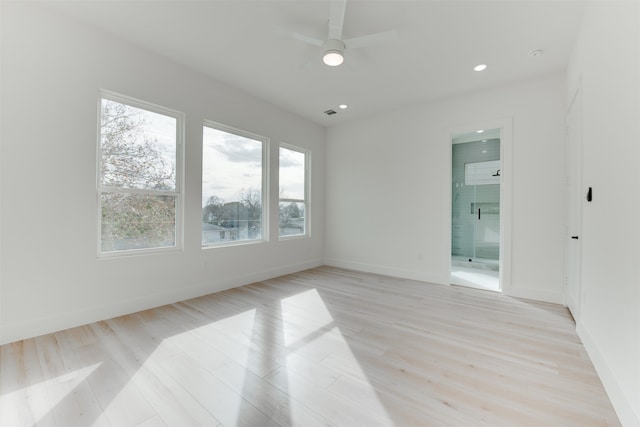 unfurnished room with ceiling fan, light wood-type flooring, and a wealth of natural light