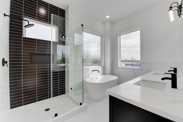 bathroom with vanity, independent shower and bath, and tile walls