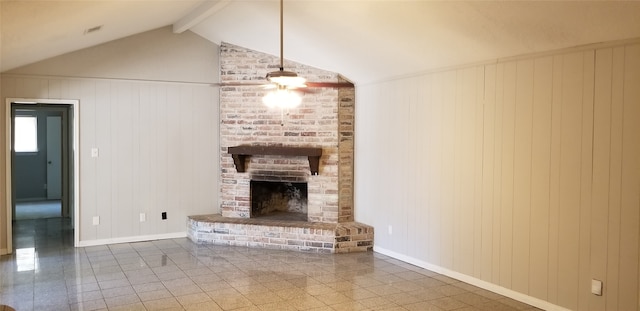 unfurnished living room featuring vaulted ceiling with beams, wood walls, and a fireplace