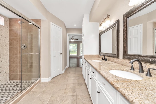 bathroom with tile patterned flooring, ceiling fan, an enclosed shower, and vanity