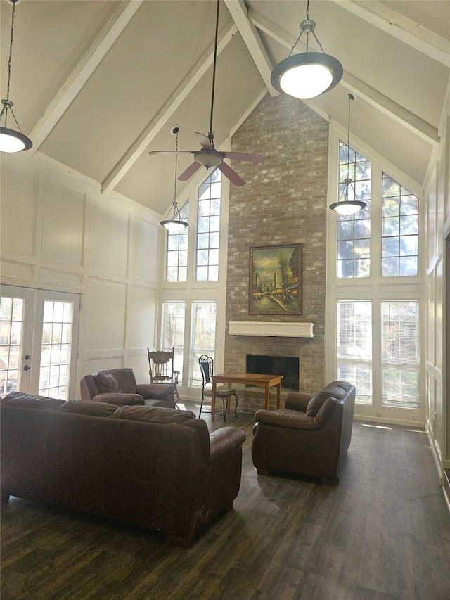 living room with plenty of natural light and high vaulted ceiling