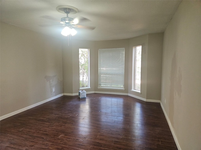 unfurnished room with dark hardwood / wood-style floors and ceiling fan