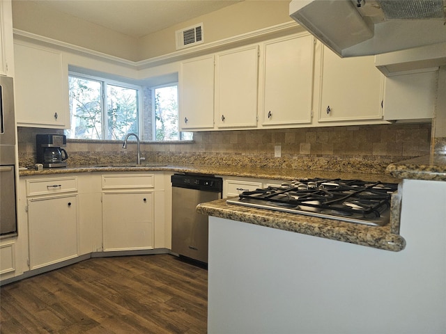 kitchen featuring ventilation hood, stainless steel appliances, dark wood-type flooring, sink, and white cabinets