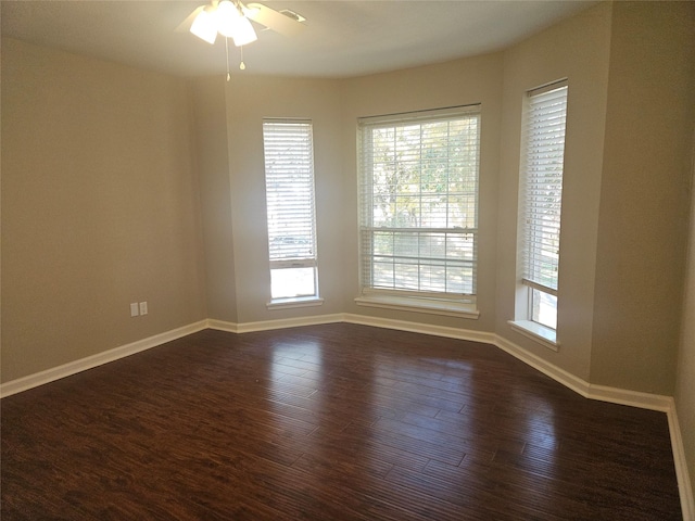 unfurnished room with ceiling fan and dark hardwood / wood-style floors