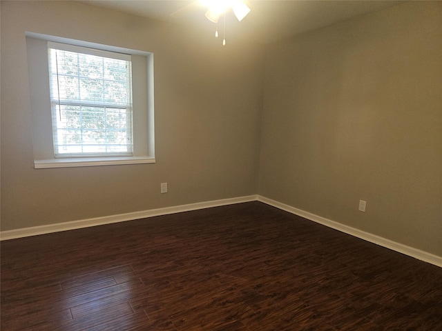 spare room with ceiling fan and dark wood-type flooring