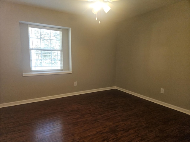 spare room with ceiling fan and dark wood-type flooring