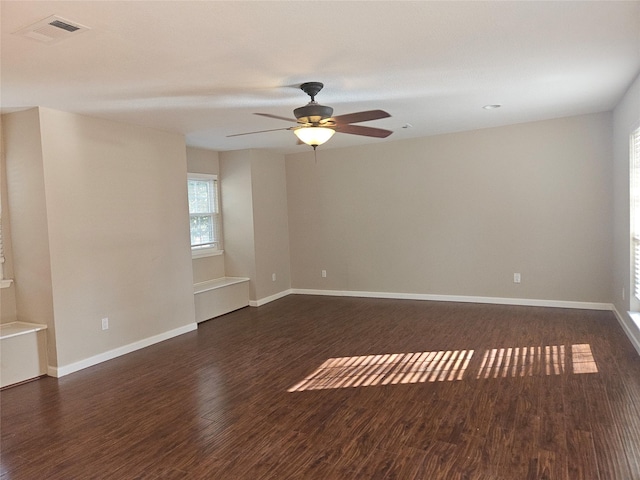 spare room featuring ceiling fan and dark hardwood / wood-style flooring