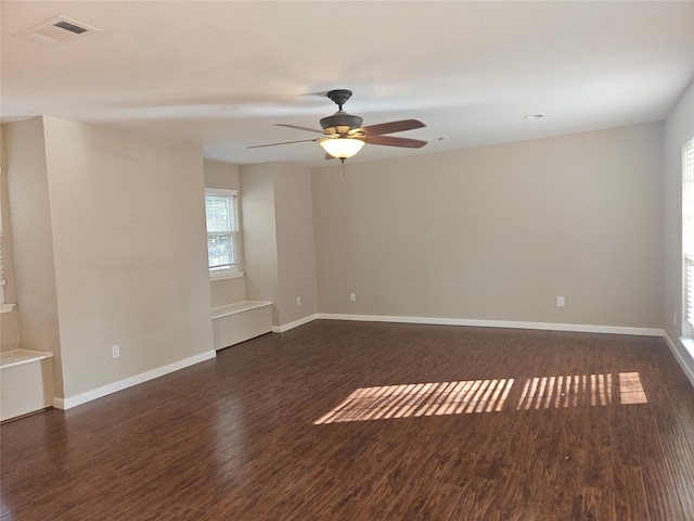 unfurnished room featuring ceiling fan and dark wood-type flooring