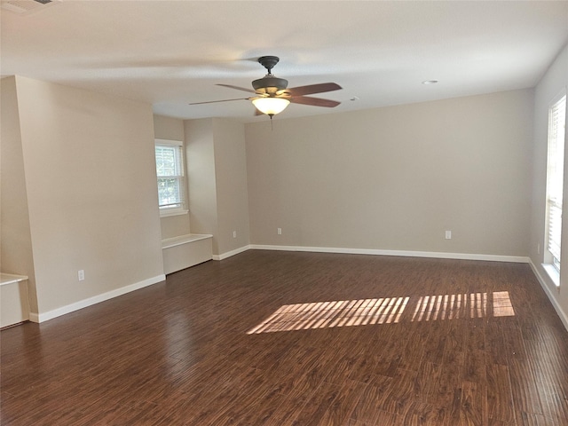 empty room featuring ceiling fan and dark wood-type flooring