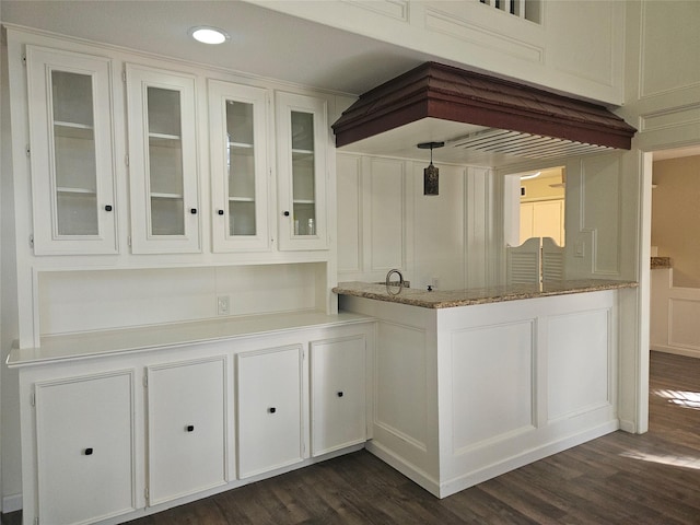 bar with white cabinetry, light stone countertops, and dark hardwood / wood-style floors