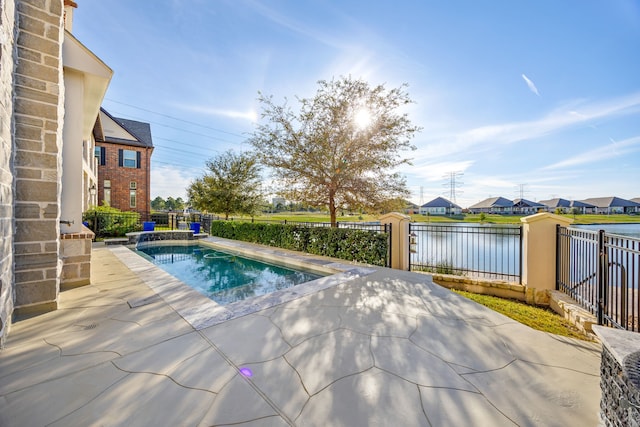 view of swimming pool with a patio and a water view