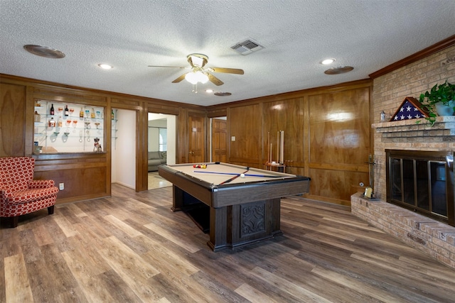 playroom featuring wooden walls, a textured ceiling, and billiards