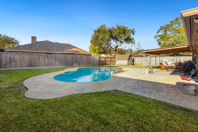 view of swimming pool with a yard and a patio