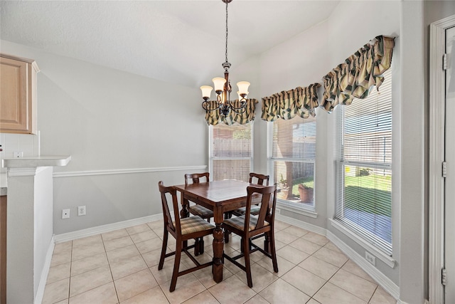 dining room with light tile patterned floors and an inviting chandelier