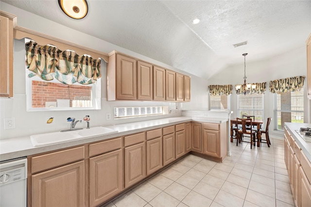 kitchen featuring an inviting chandelier, white dishwasher, sink, hanging light fixtures, and a textured ceiling