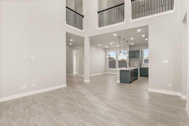 living room featuring a towering ceiling and sink