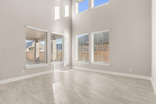 unfurnished room featuring a high ceiling