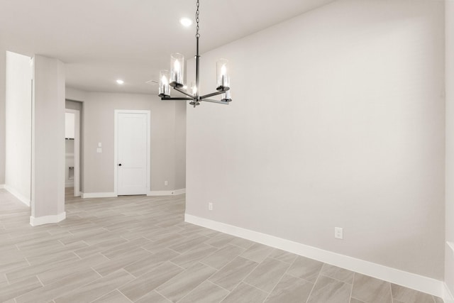 unfurnished dining area featuring a notable chandelier