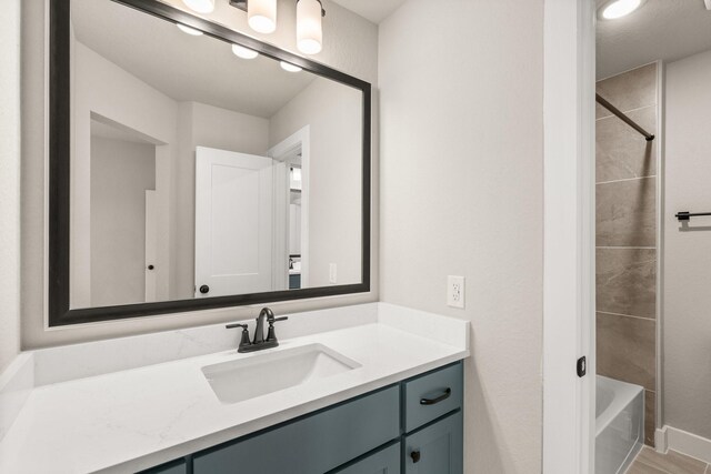 bathroom with vanity and bathing tub / shower combination