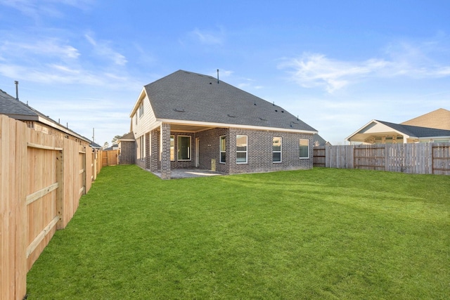 rear view of property featuring a patio and a lawn