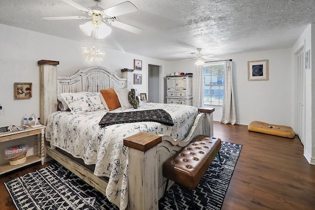 bedroom with a textured ceiling, dark hardwood / wood-style floors, and ceiling fan with notable chandelier