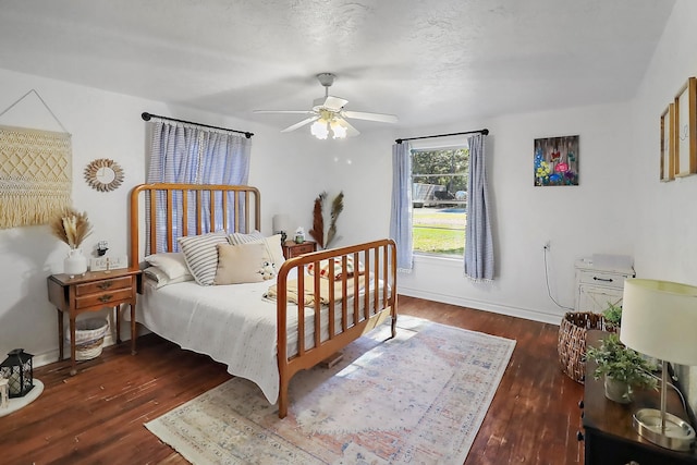 bedroom with dark hardwood / wood-style flooring and ceiling fan