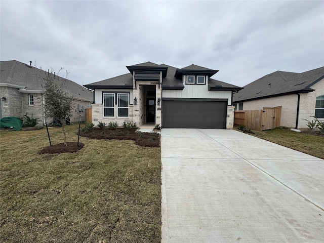 prairie-style home with a garage and a front lawn