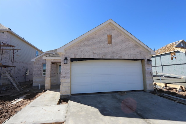 ranch-style home with a garage, brick siding, and driveway