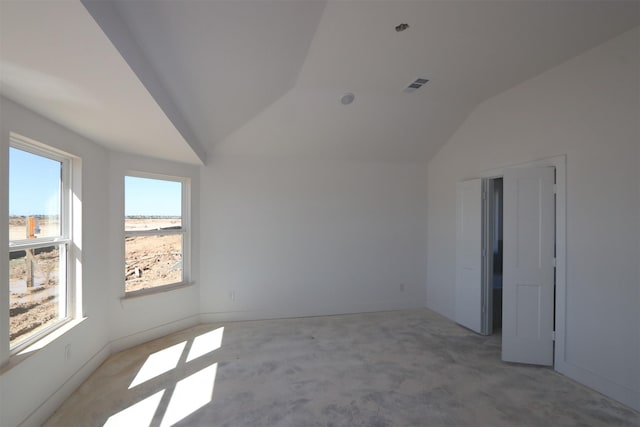 unfurnished room with lofted ceiling and visible vents