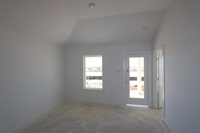 empty room with lofted ceiling