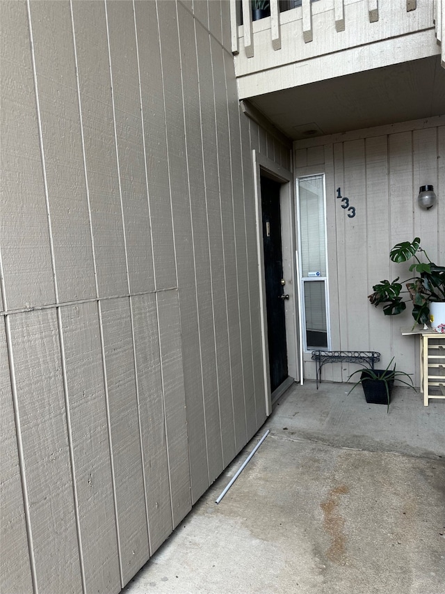 entrance to property featuring a balcony and a patio