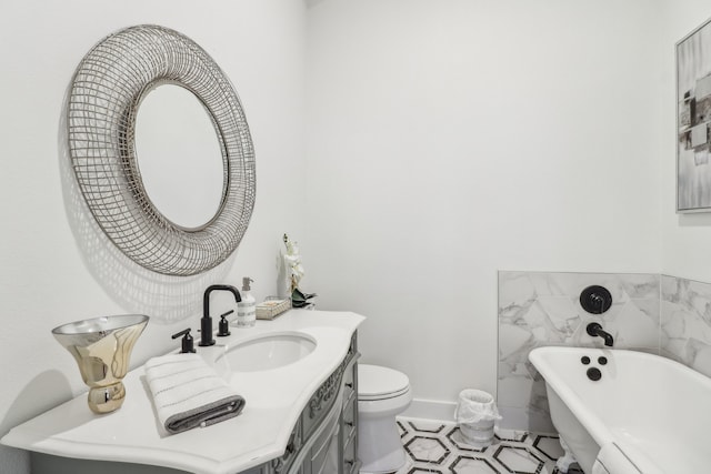 bathroom with vanity, tile patterned flooring, toilet, a tub to relax in, and tile walls